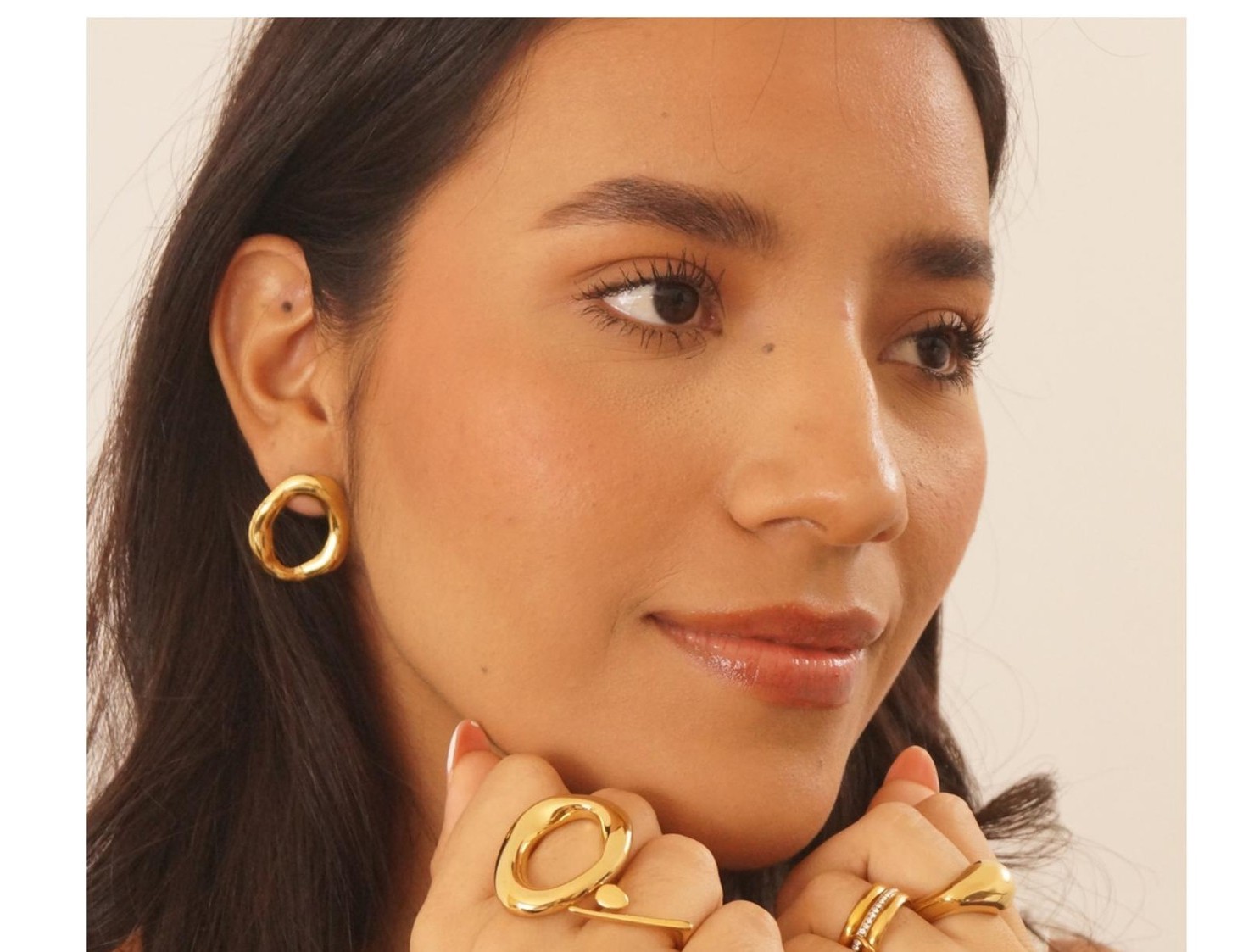 Retrato editorial con aretes Oru y anillos apilados